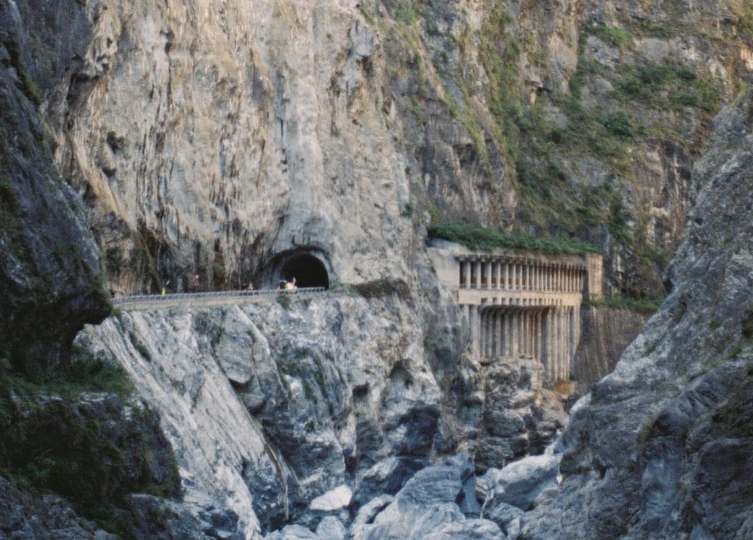 The winding gorge road cuts into the mountain face